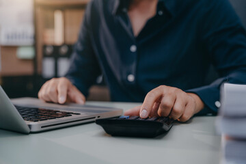 Male are calculating income-expenditure and analyzing real estate investment data at office.