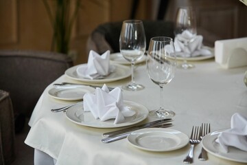 Crystal glasses for celebration, decorated for the holiday. Table setting.