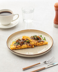 Portion of gourmet omelette with mushrooms and cheese