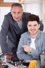 portrait of senior technician with his apprentice