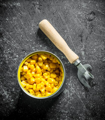 Open tin can with canned corn.