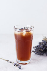 Cold cocktail with ice and lavender in a glass.