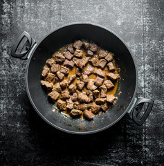 Fried liver in a pan.