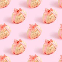 Bright pink human brain with satin bow repeat seamless pattern on pastel background. Creative wrapping paper concept.