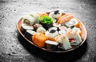 Different kinds of sushi rolls on the plate.