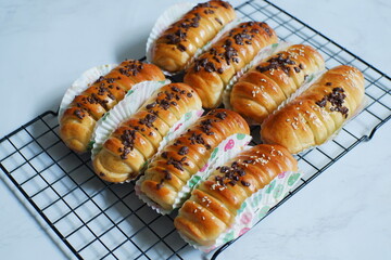 baked rolls bread in wire cooling rack