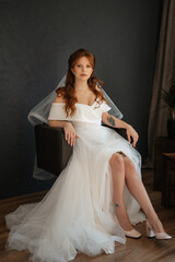 Fototapeta premium portrait of a bride girl with red hair in a white wedding dress