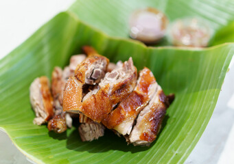 roasted duck ready to serve on green banana leaf