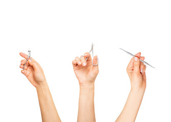 hands hold tools for manicure and pedicure, on a white background, scissors for manicure,nail nippers and a curette,
