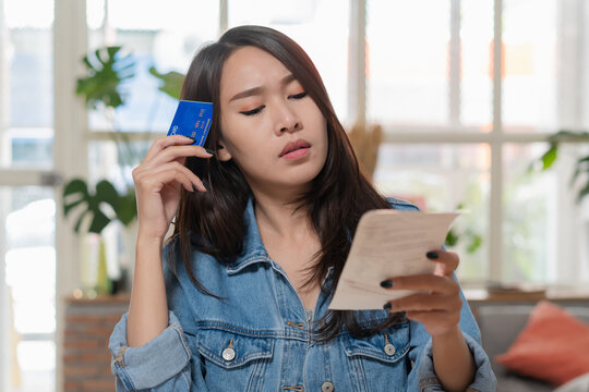 Woman doing accounting home finance expenses and calculate credit card monthly debt to bills payment.