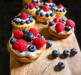 Freshly baked baskets with curd cream  and strawberries 