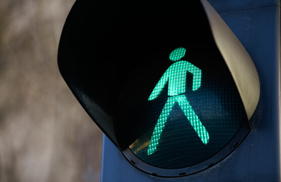 Pedestrian Traffic Green Light Sign Allowing Poeple To Cross The Street. Infrastructure Industry Concept Photo.