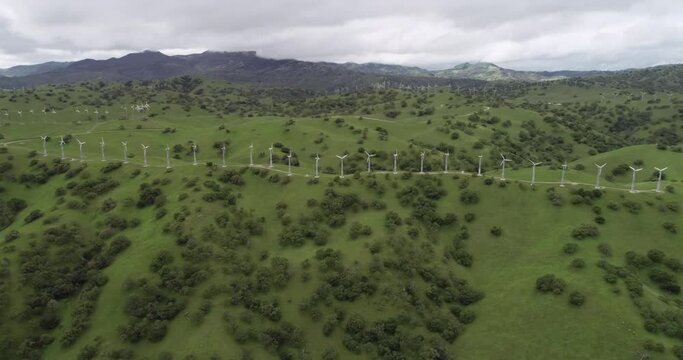 Windmills in Upper Cottonwood Creek Wildlife Area near Los Banos. California. USA. Mountains in Background