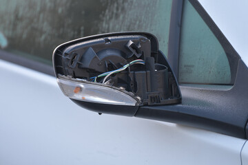 Closeup of a side broken rearview mirror of a car. car detail