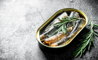Sprats in a tin can of rosemary.