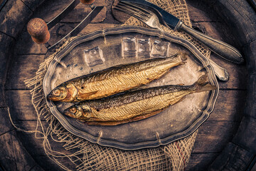 Smoked fish in a traditional way on a rustic background