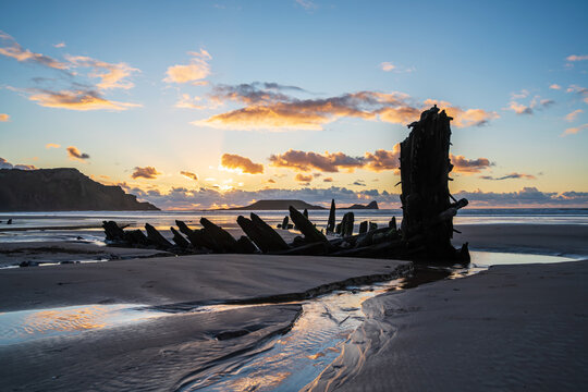 Wreck of Helvetia at sunset, Rhossili Bay beach, no people. Gower Peninsula, South Wales, the United Kingdom, UK GB.