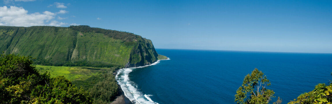 The Big Islands famous black sand beaches scene in a distance at the Waipio Valley Overlook, Hawaii.