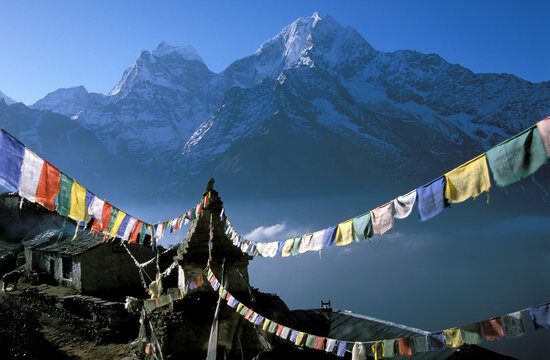 First light of day illuminates Kantega and Thamserku from Mong La pass, Nepal Himalaya.