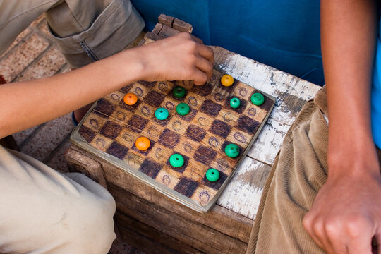 Kids playing draughts the medina (old town). Essaouira, Morocco.