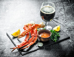 Boiled crab with sauce and beer in a glass. © Artem Shadrin