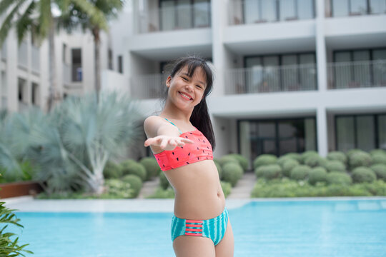 Happy girl enjoying summer vacations in a pool. Summer holidays, children's swimming, Pool woman on holidays in tropical resort swimming. summer vacation concept.