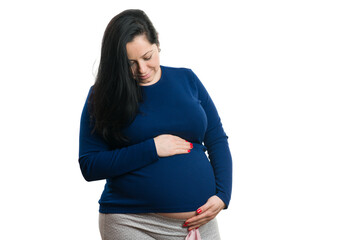 Young pregnant woman checking her belly on white background