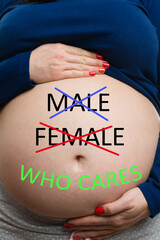Close-up of who cares text on pregnant belly