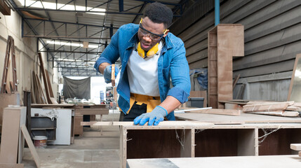 Male carpenter working with skill in carpentry workshop. Professional joiner work with manual tool equipment in woodwork. Portrait of woodworker making or repairing furniture. Craftsman industry.