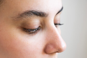 Fototapeta premium Close-up of a caucasian woman after eyelash lamination procedure. 