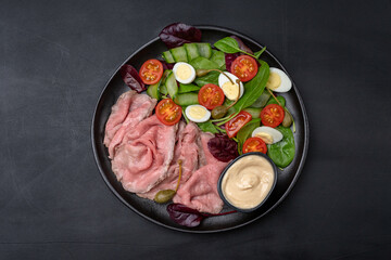 Roast beef with spinach salad and quail eggs healthy lunch keto diet food