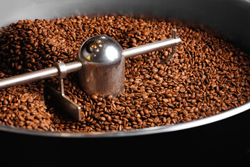 Brown coffee beans roasting process on professional roaster machines, top view