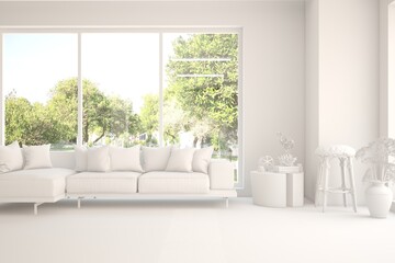Fototapeta premium Mock up of stylish room in white color with sofa and green landscape in window. Scandinavian interior design. 3D illustration