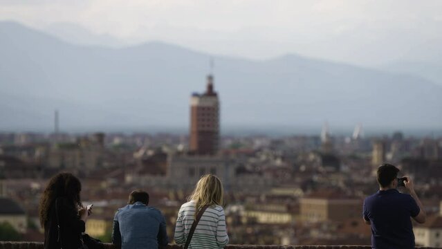 Tourists looking over skyline of city Turin in Italy taking pictures