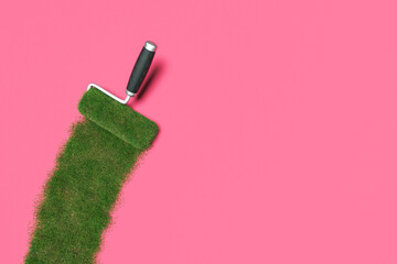 roller painting lawn on pink surface