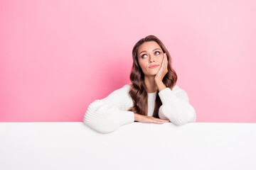 Portrait of minded girl hand touch cheek look empty space brainstorming isolated on pink color background