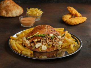 Delicious hamburger and french fries on wooden background