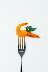 close-up of a shrimp chopped on a fork on a white background