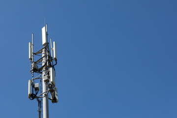 Telecommunications tower with 4G, 5G transmitters. Cellular base station with transmitting antennas...