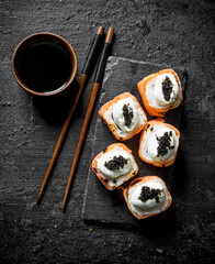 Fresh rolls with salmon, cream cheese and caviar.