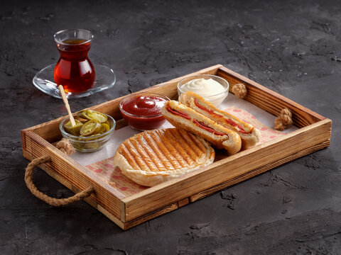 Turkish Tost / Toast Sandwich with Melted Cheese and Sucuk / Sujuk served with Salad. Sausage and roasting meat toasted.