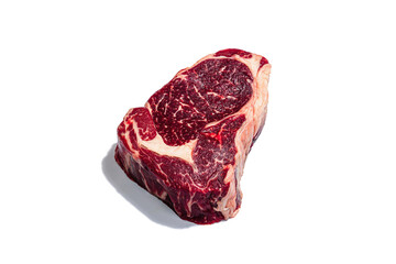 Raw Ribeye steak with spices and herbs isolated on white background. Trendy hard light, dark shadow