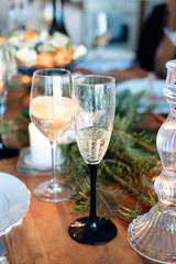 two glasses with alcohol on the New Year's table. glass of champagne and cocktail with lemon in a glass