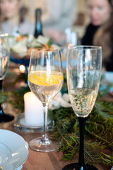 two glasses with alcohol on the New Year's table. glass of champagne and cocktail with lemon in a glass