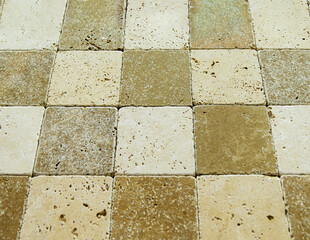 Texture square stone floor tiles. Natural travertine aged with open pores. Background