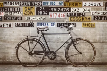 Garden poster Bike Ancient bicycle in front of an old factory door