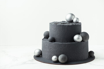 Anniversary luxury black bunk cake with chocolate velvet coating isolated on white background....
