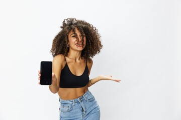 Woman blogger with phone in hand on white background selfies, video call, freelancer influencer job in social media and media, technology for work, smile curly hair copy spot