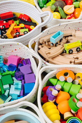 Colorful Toy Storage Baskets in the children's room. Cloth stylish Baskets with wooden toys. Organizing and Storage Ideas in nursery. Clean up toys and reduce the clutter. Top view