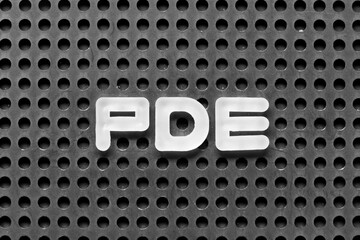 White alphabet letter in word PDE (abbreviation of permitted daily exposure, partial differential equation or personal development education) on black pegboard background